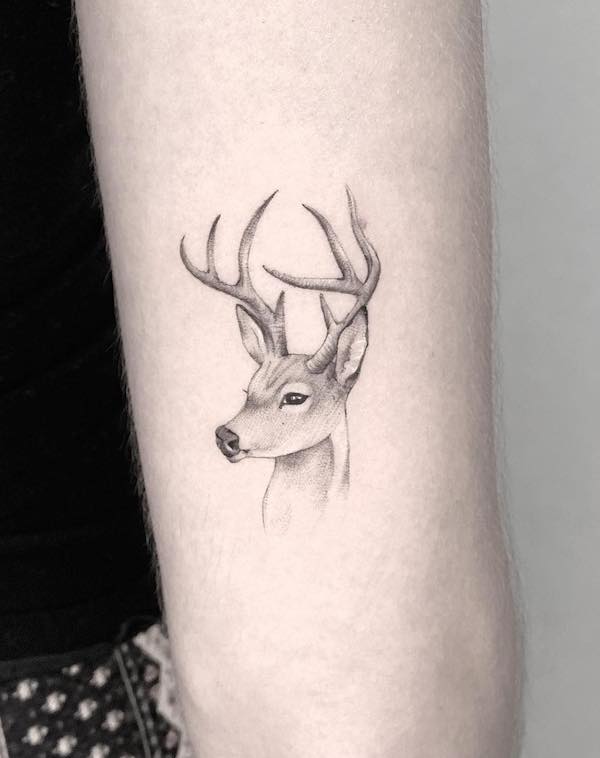 Simple small deer head tattoo by @szilvia.tattoo