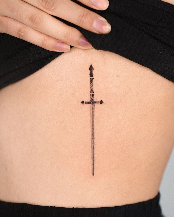 Simple sword rib tattoo by @choiyun_tattoo