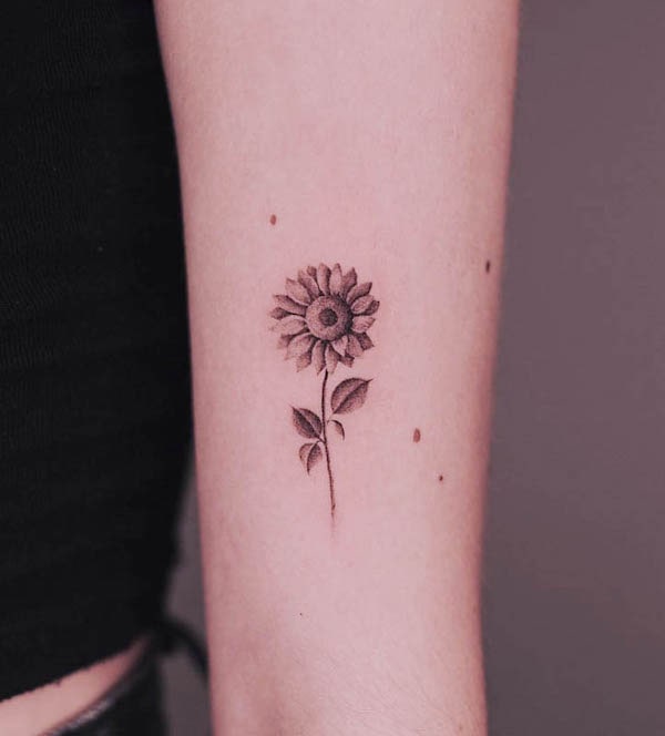 Simple tiny sunflower tattoo by @clealtattoo