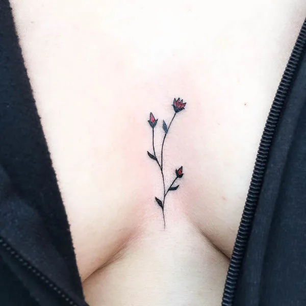 Small between the boobs flower tattoo by @agataris