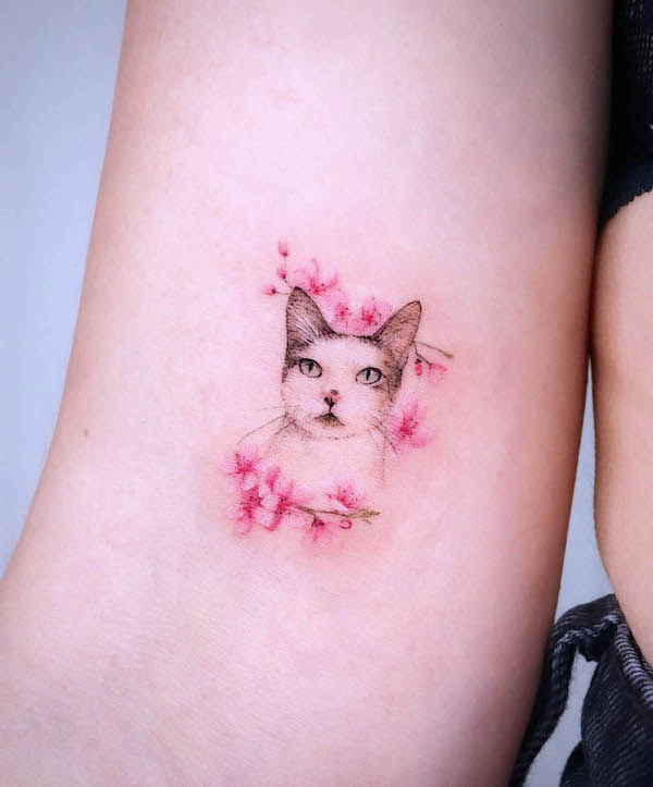 Small cherry blossom cat tattoo by @eunyutattoo