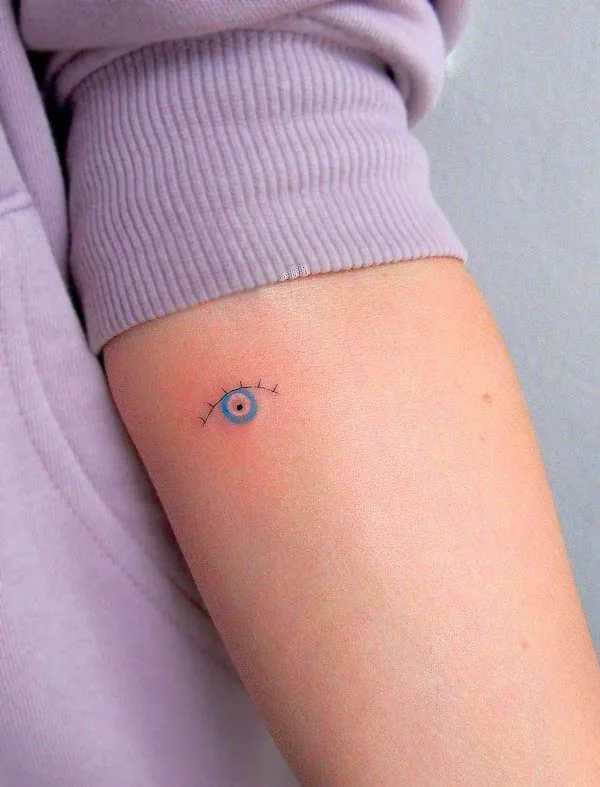 Small evil eye arm tattoo by @deni.tattooing