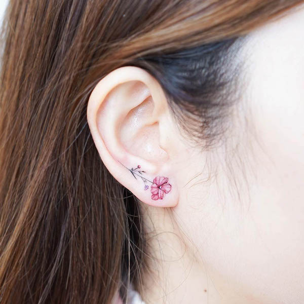 Small flower lobe tattoo by @mini_tattooer