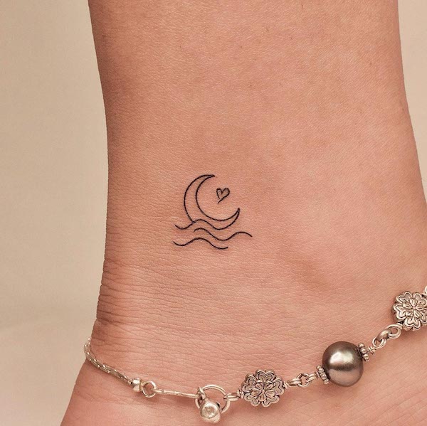 Small moon and ocean ankle tattoo by @tattooer_jina