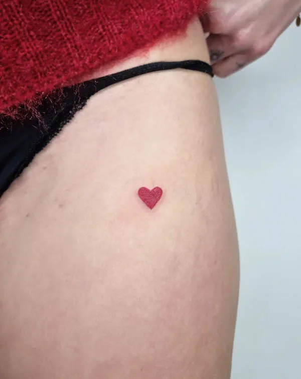 Small simple red heart tattoo by @klaeg_tattoo