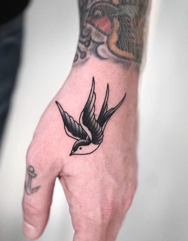 Small swallow hand tattoo by @frankrochatattoo