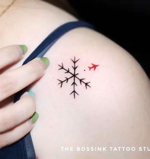 Snowflake and plane tattoo by @thebossinktattoopiercingstudio