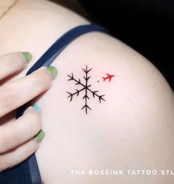 Snowflake and plane tattoo by @thebossinktattoopiercingstudio