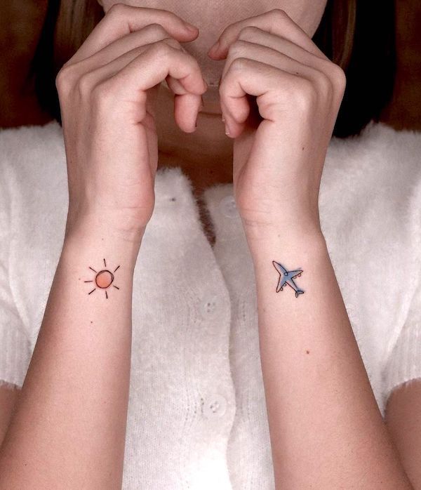 Sun and airplane wrist tattoos by @fawn.ink_