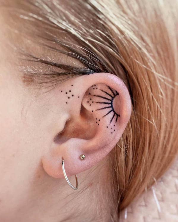 Sun tattoo on the inner ear tattoo by @silvia_tattoo