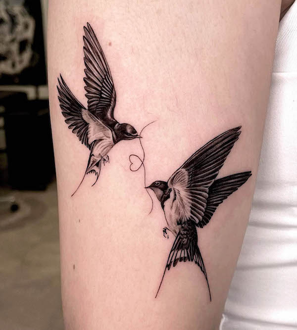 Swallow and heart tattoo by @hoa._.tattoo