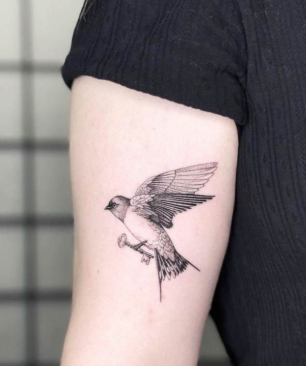 Swallow holding a key tattoo by @celesteciafarone