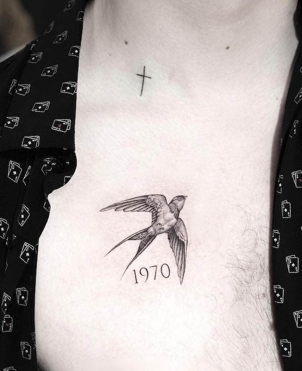 Swallow with year of birth tattoo by @indira_txttoo