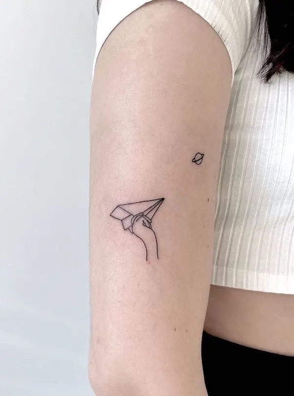 Throwing a paper airplane tattoo by @eslstudent