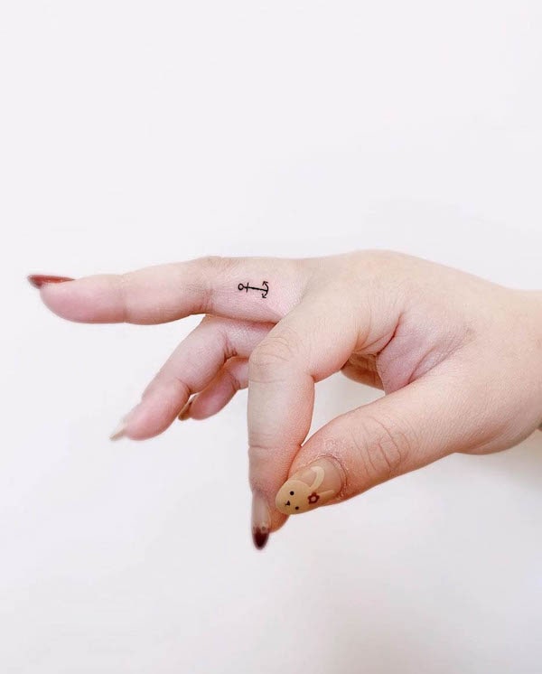 Tiny anchor inner finger tattoo by @thevirtues_beauty_tattoos