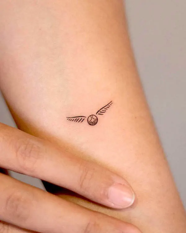 Tiny golden snitch Harry Porter tattoo by @handitrip