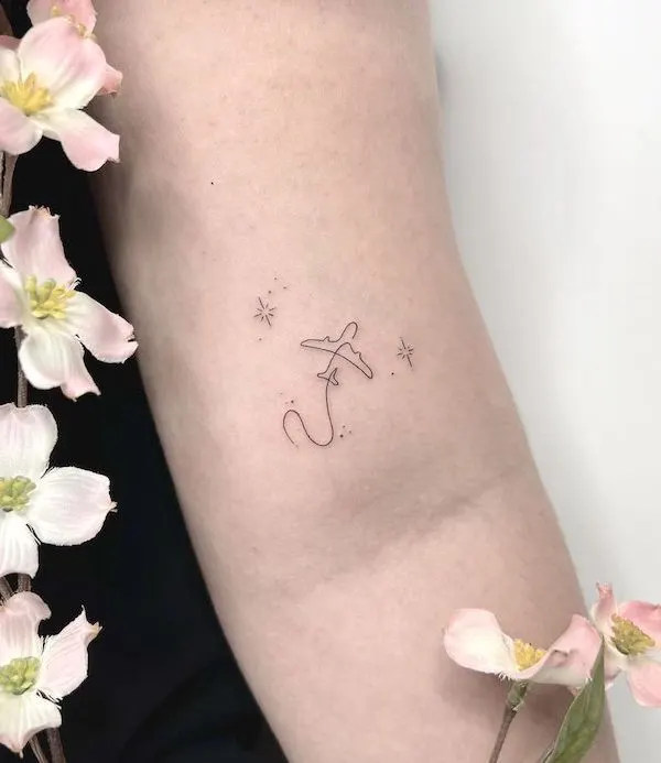 Tiny minimalist plane tattoo by @kiristattoo