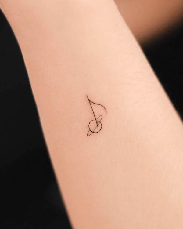 Tiny musical note side wrist tattoo by @nhi.ink