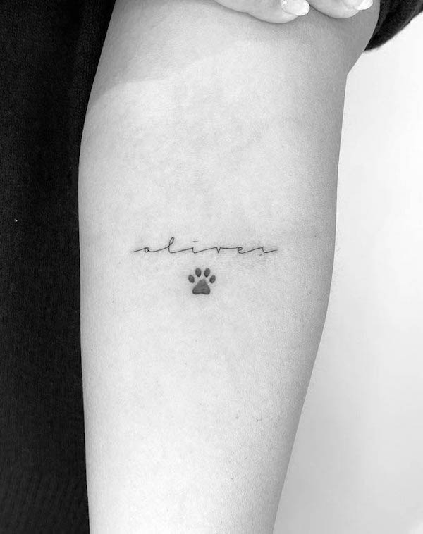 Tiny paw arm tattoo by @loko_lines