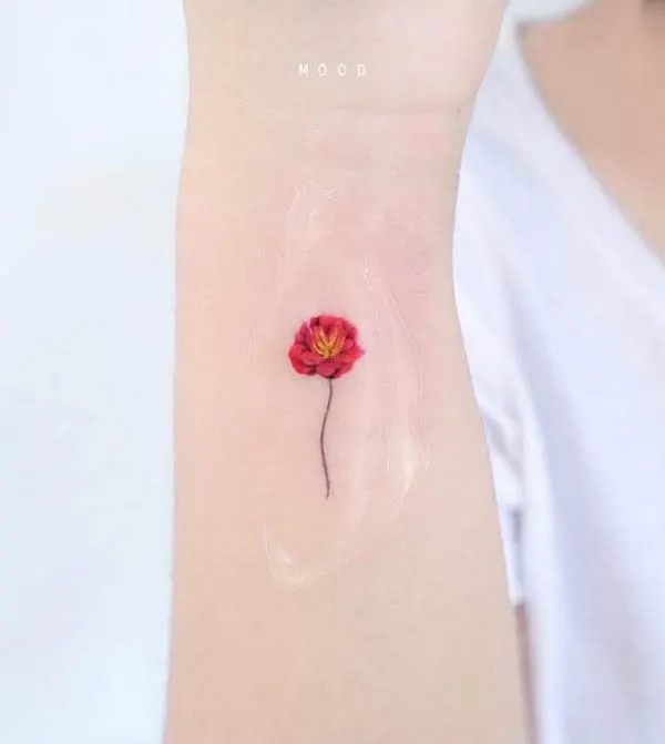 Tiny red flower wrist tattoo by @notorious__ing