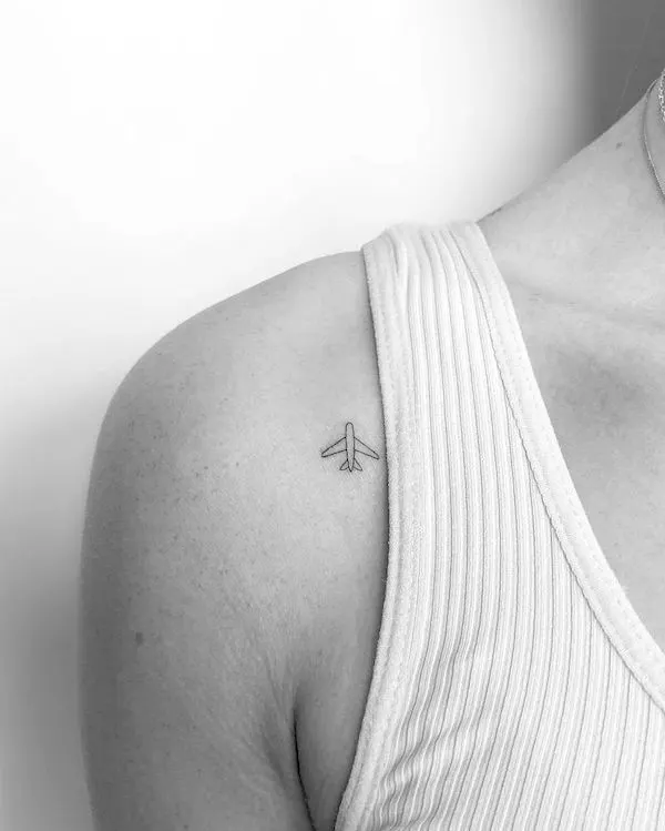 Tiny shoulder plane tattoo by @mrs.tattoo