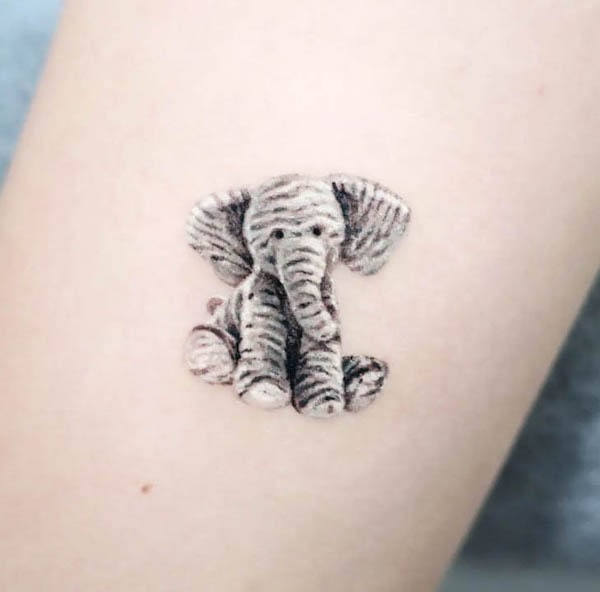 Toy elephant tattoo by @eins_tattooer