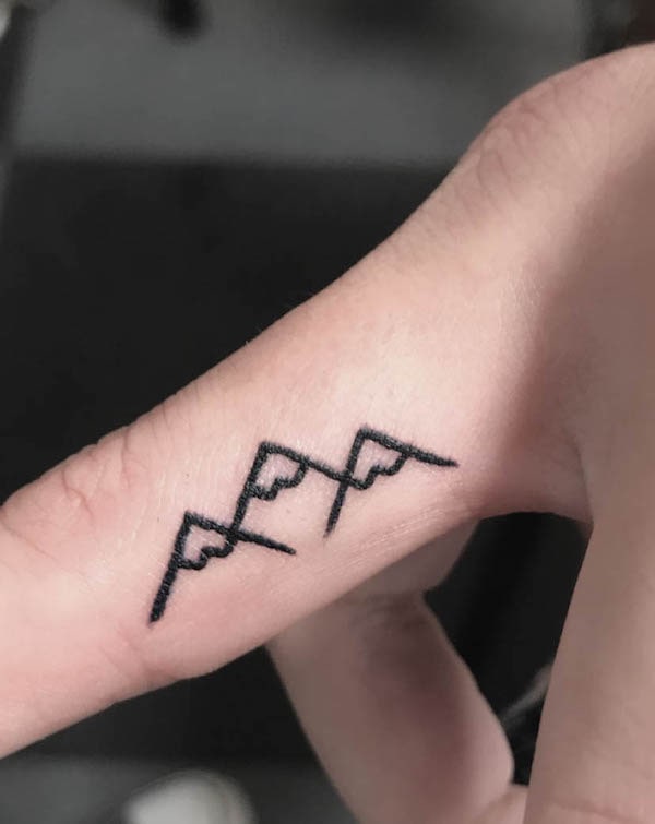 Triangle mountains finger tattoo by @wraithtattoos