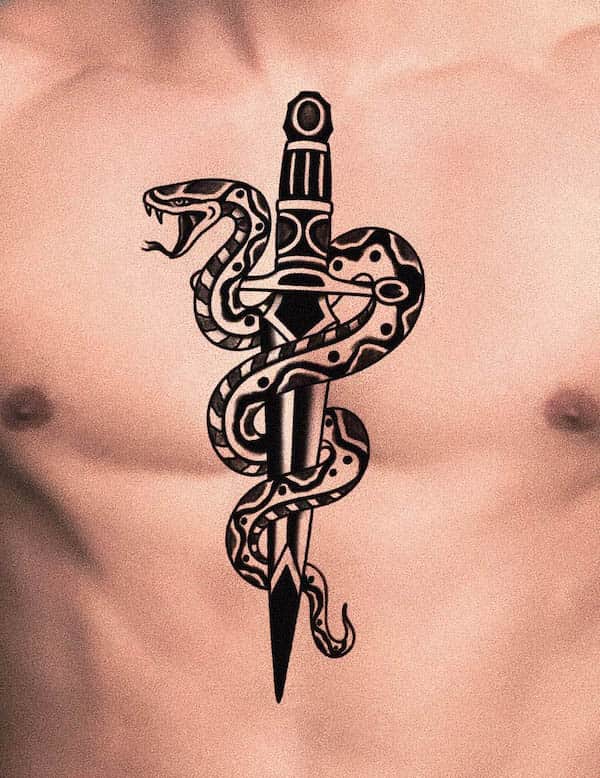 Tribal style snake and dagger tattoo by @nico_tattoos