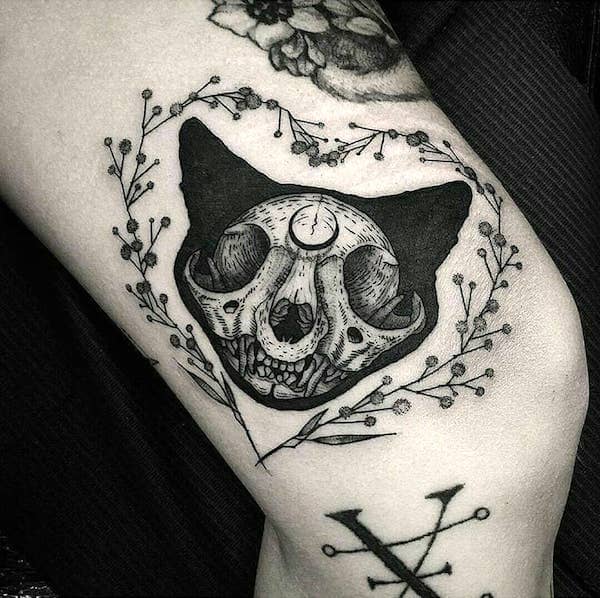 A black cat skull tattoo- The Familiar animals tattoos for witches