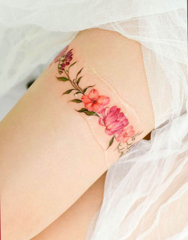 Flower thigh band tattoo by @yerae_tt