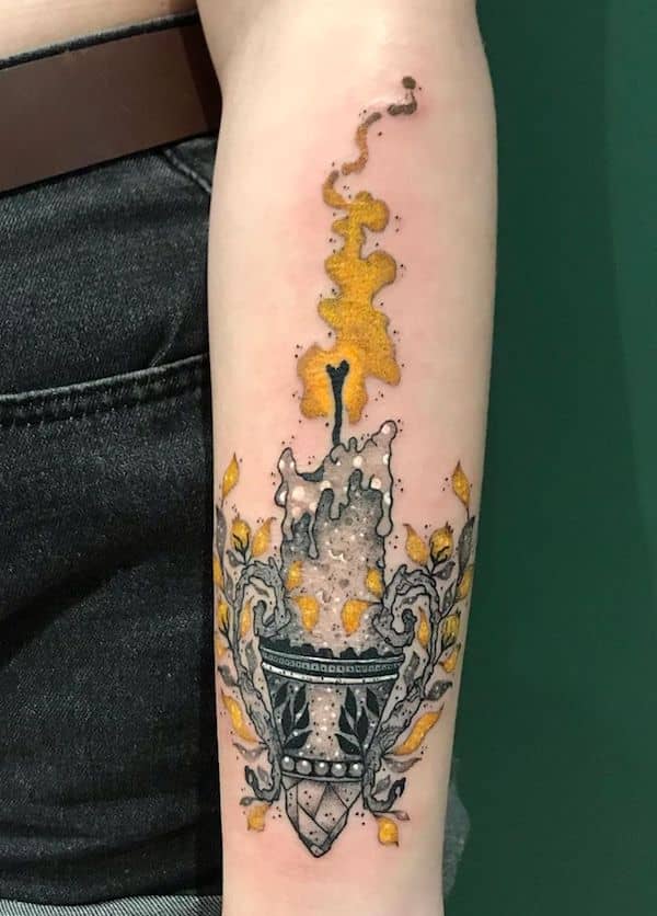 The burning candle forearm tattoo by @lecygnenoir_tattooshops- Fantasy Magic tattoos