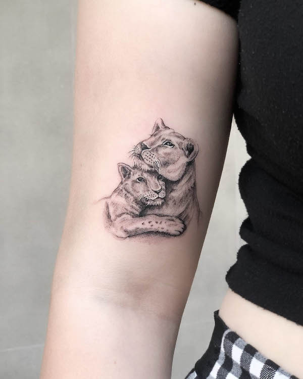 Cute mother and baby lion tattoo by @bigboy.tattoo