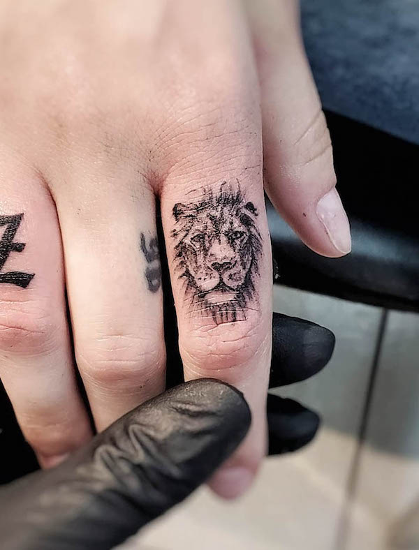 Lion finger tattoo by @tattoosbysuzy