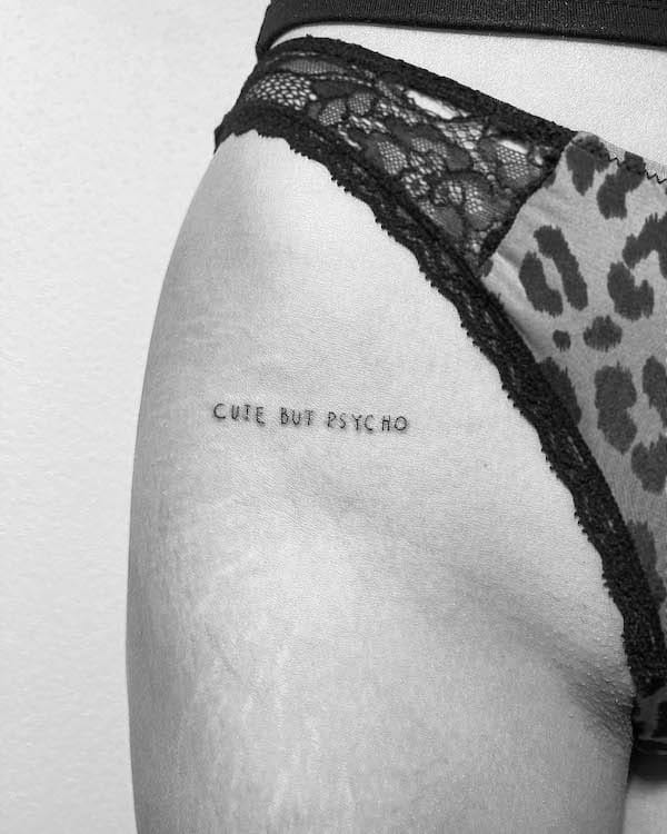 Upper thigh statement tattoo by @line.art_.tattoo