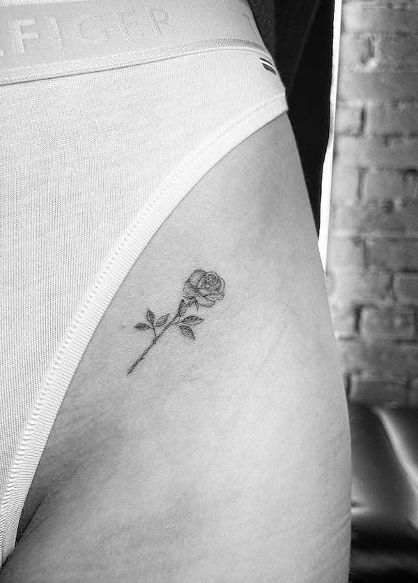 small thigh rose tattoo by @line.art_.tattoo