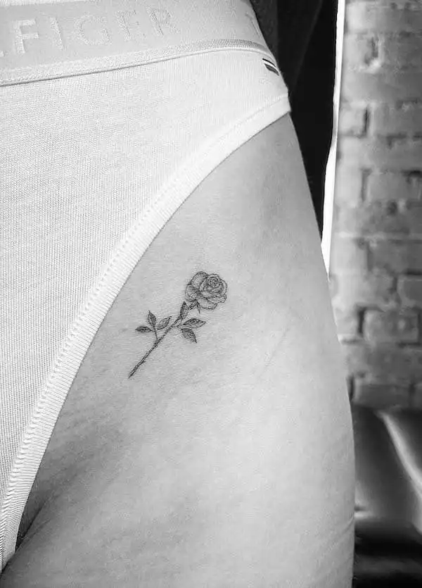 small thigh rose tattoo by @line.art_.tattoo