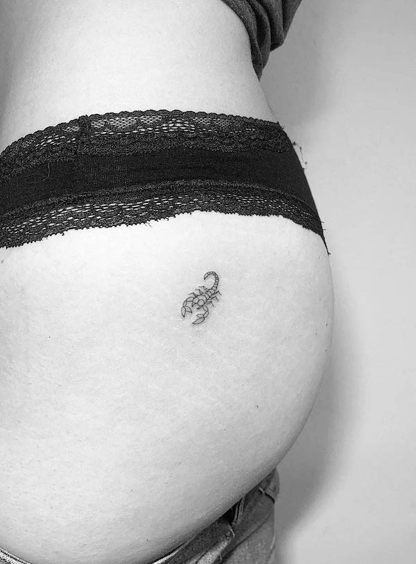 Small Scorpio thigh tattoo by @line.art_.tattoo