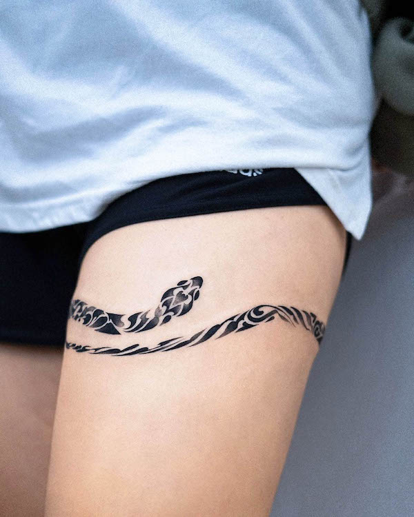 Snake thigh band tattoo by @e.nal_.tattoo