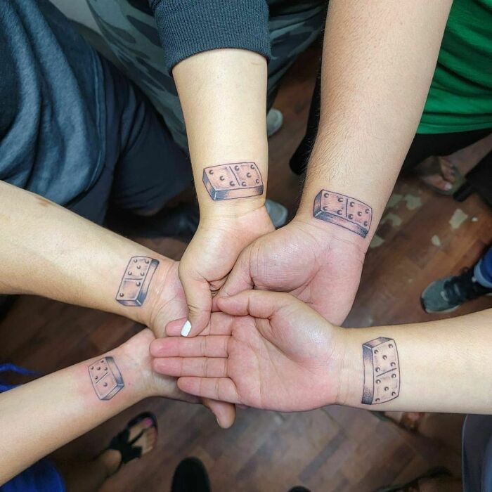 Domino's wrist tattoos