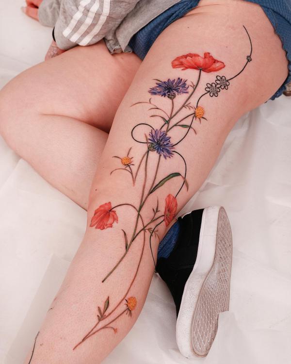 Cornflower and poppy leg tattoo