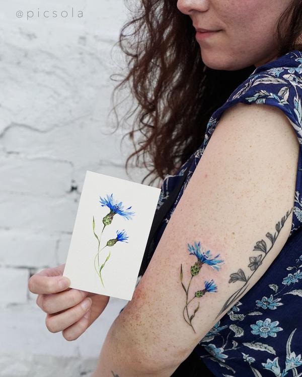 Cornflower tattoo above elbow tattoo